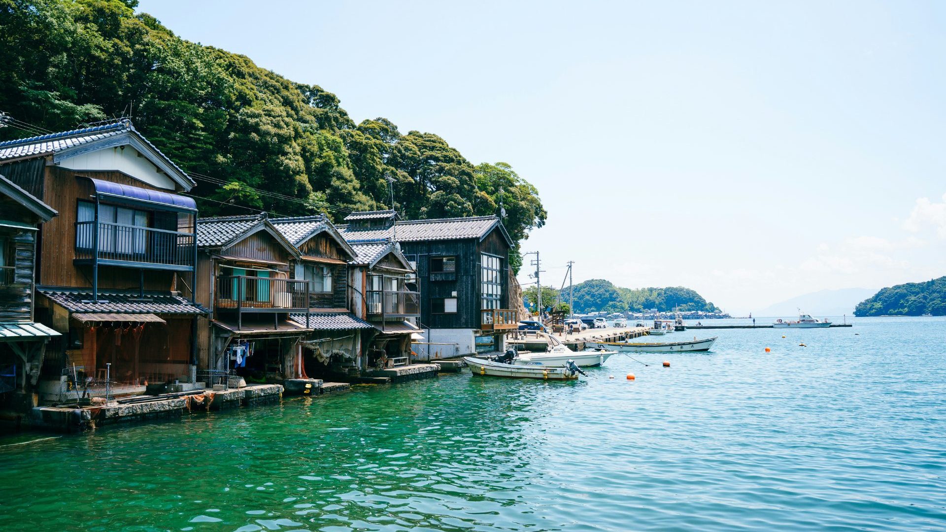 Wooden houses built on top of green water.