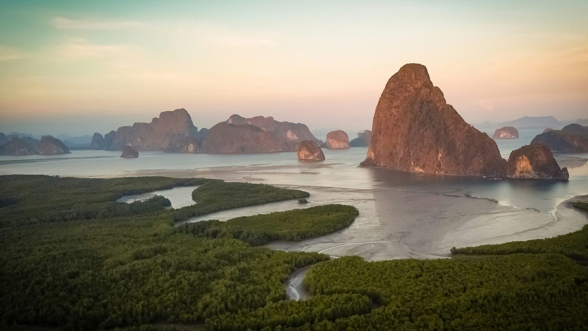 Curved green coastline with limestone karst islands