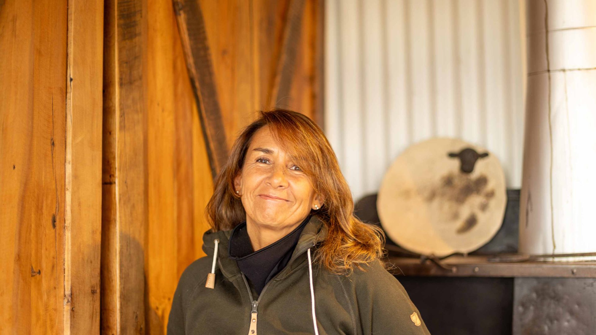 A woman with blonde hair smiles to camera.