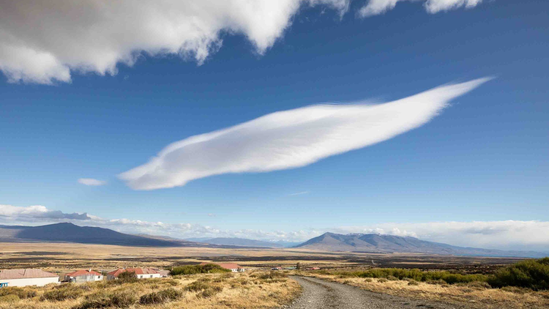 Stunning sky over plains and buildings.