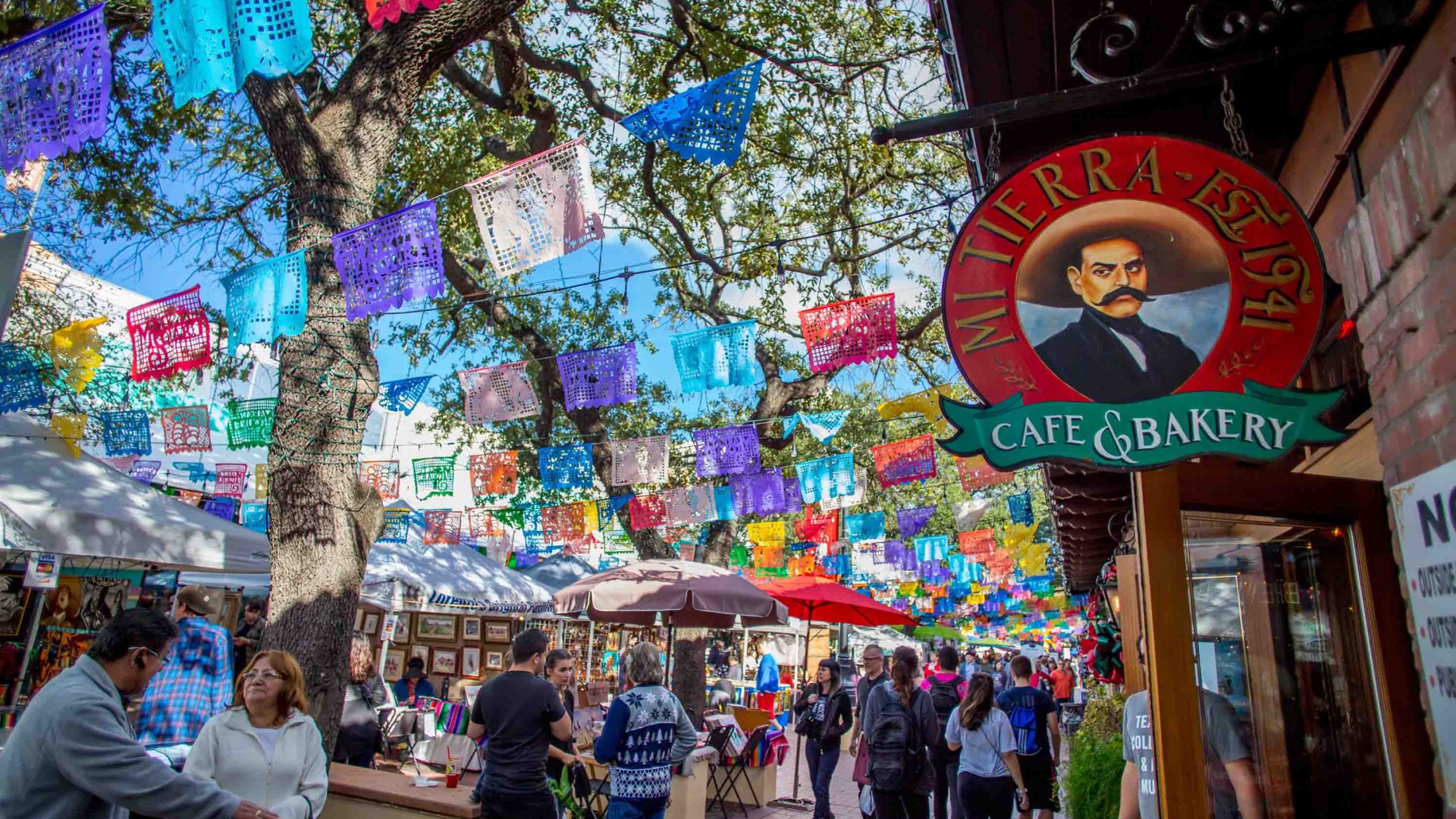 A bustling market street with colorful bunting.