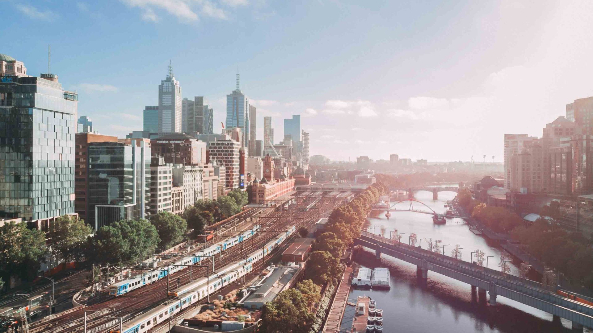 A drone photo of a city with a river running through it.